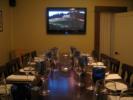 A linear shot of a board room style setup in our private Wine Room.